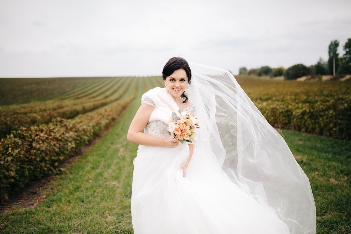Happy Wedding Couple Hugging and Smiling Each Other on the Background Gorgeous Plants